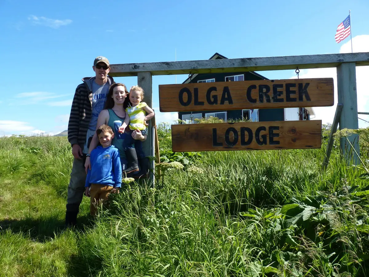 The Olga Creek Lodge sign and lodge family